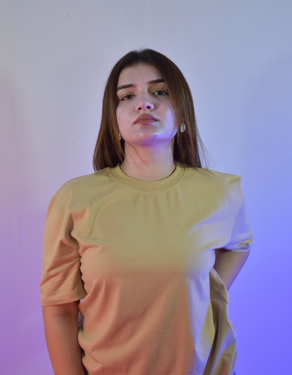 Beige oversized t shirt with bold “Karma” text and symbolic circular graphic – streetwear fashion graphic tee for men and women.