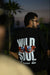 Black oversized t shirt with tiger eyes graphic and bold text “Wild Soul will never die” – streetwear fashion graphic tee for men and women.