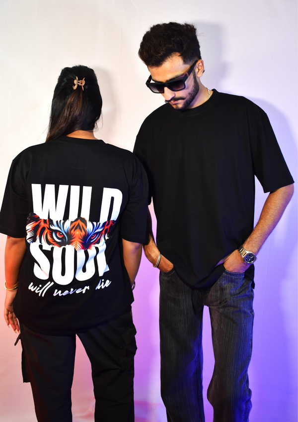 Black oversized t shirt with tiger eyes graphic and bold text “Wild Soul will never die” – streetwear fashion graphic tee for men and women.