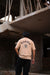 Beige oversized t shirt with bold “Karma” text and symbolic circular graphic – streetwear fashion graphic tee for men and women.